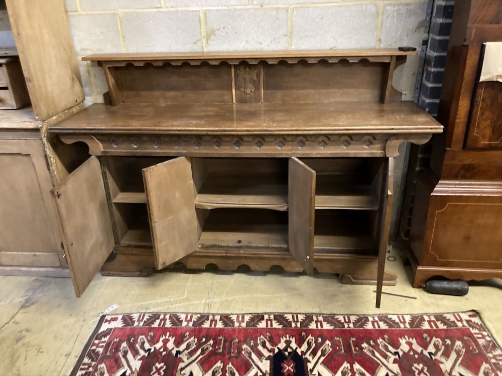 A 1930s oak Gothic inspired sideboard, width 180cm depth 50cm height 116cm